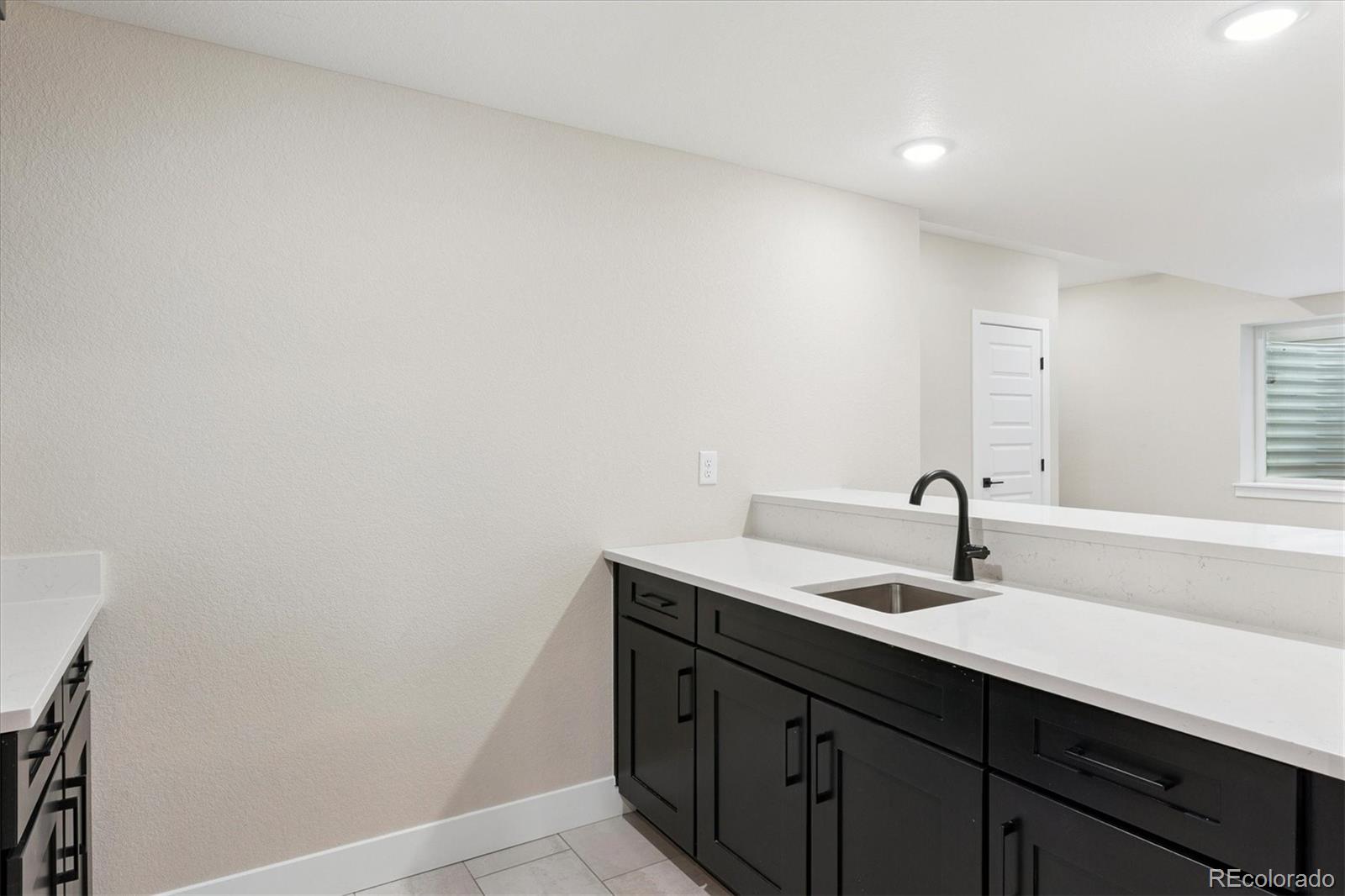 1288 Oleander Street Castle Rock, CO 80109 - Photo 19 of 29 a bathroom with a sink and a mirror