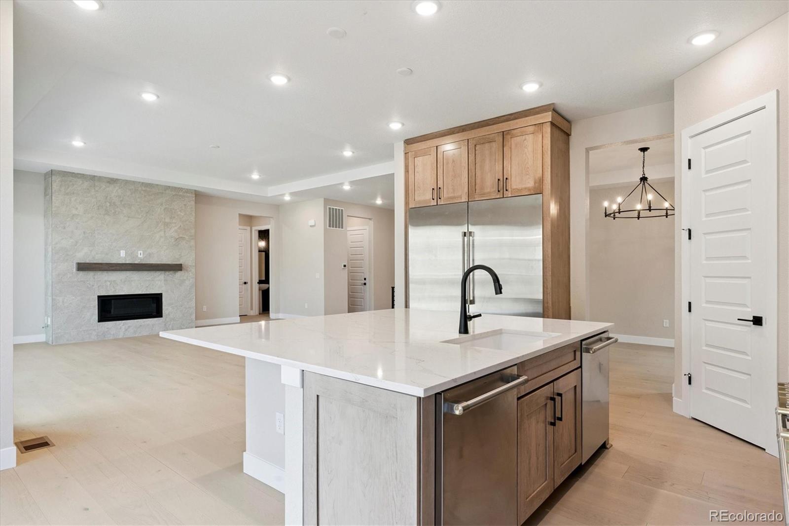 1288 Oleander Street Castle Rock, CO 80109 - Photo 6 of 29 a view of kitchen with stainless steel appliances granite countertop a stove and a sink with wooden floor