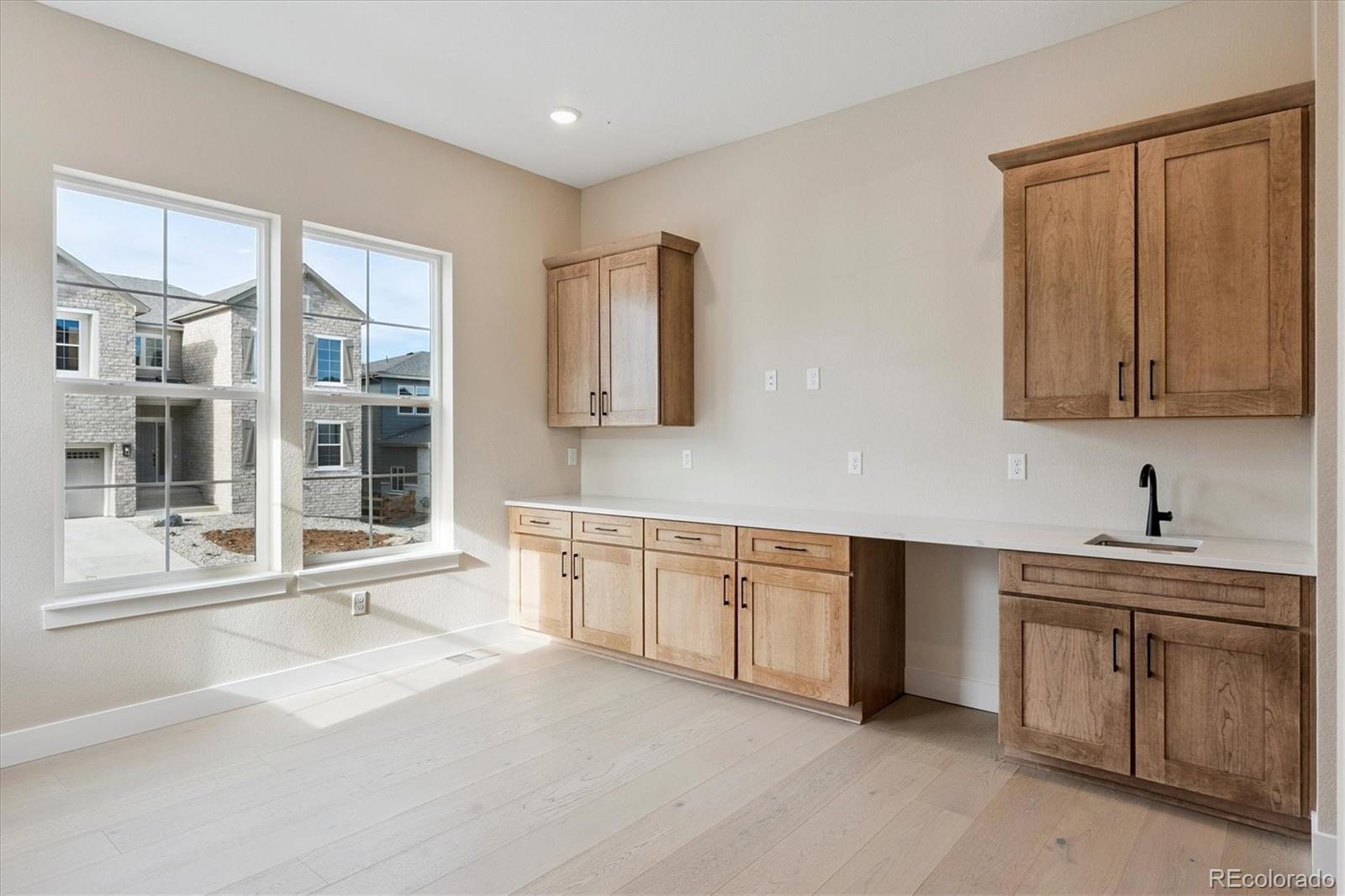 1288 Oleander Street Castle Rock, CO 80109 - Photo 8 of 29 a large kitchen with granite countertop a sink and dishwasher a stove with granite countertops