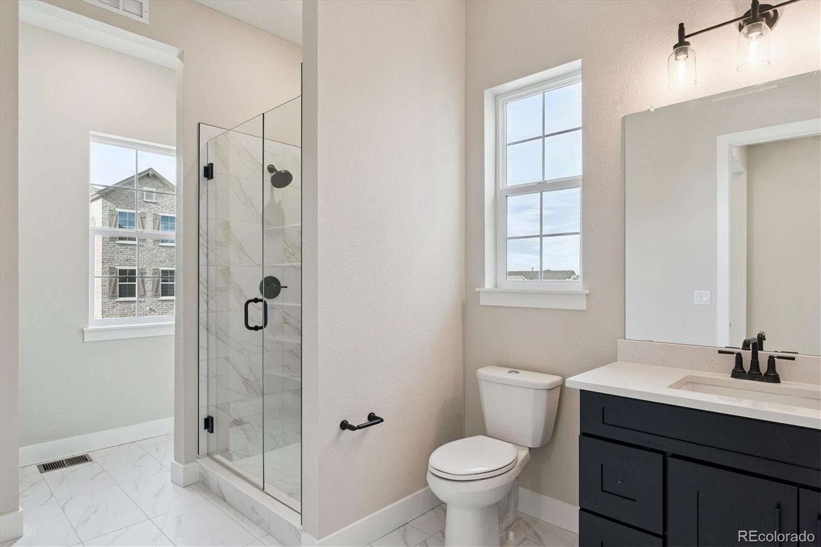 1288 Oleander Street Castle Rock, CO 80109 - Photo 9 of 29 a bathroom with a sink a toilet and shower