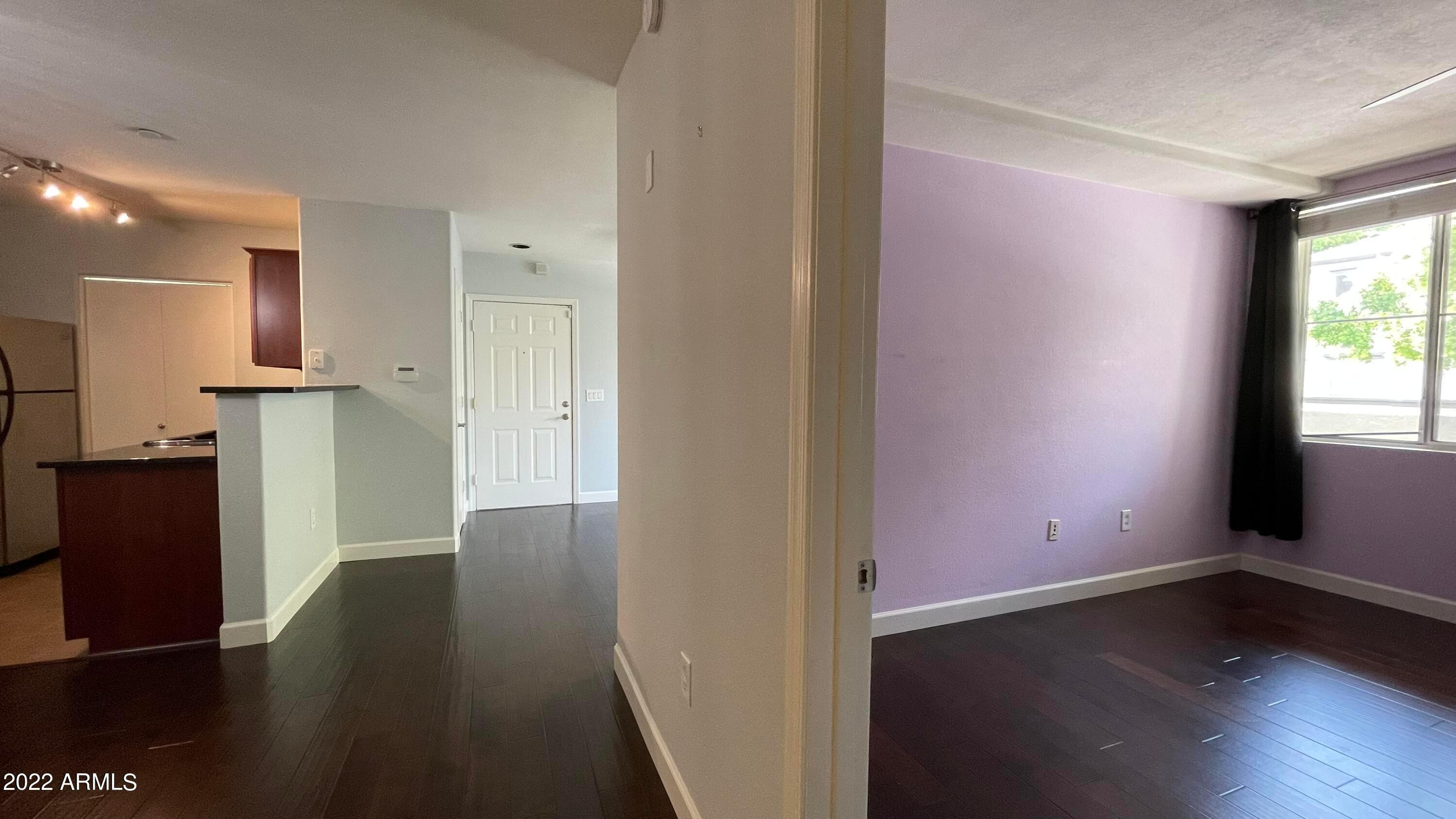 3302 North 7th Street, Unit 222 Phoenix, AZ 85014 - Photo 14 of 30 an empty room with wooden floor and windows