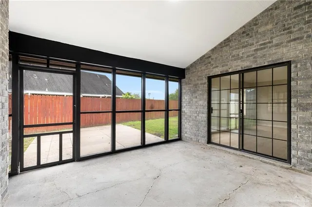 a view of an empty room with large windows