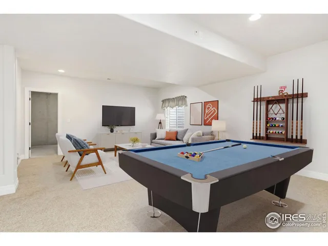 a living room with furniture and flat screen