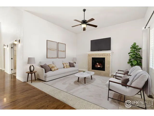 a living room with furniture a fireplace and a flat screen tv