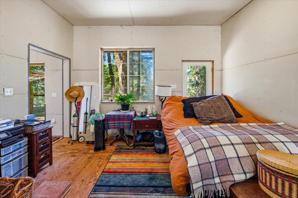 19643 Sages Road Nevada City, CA 95959 - Photo 15 of 39 a bedroom with a bed and wooden floor
