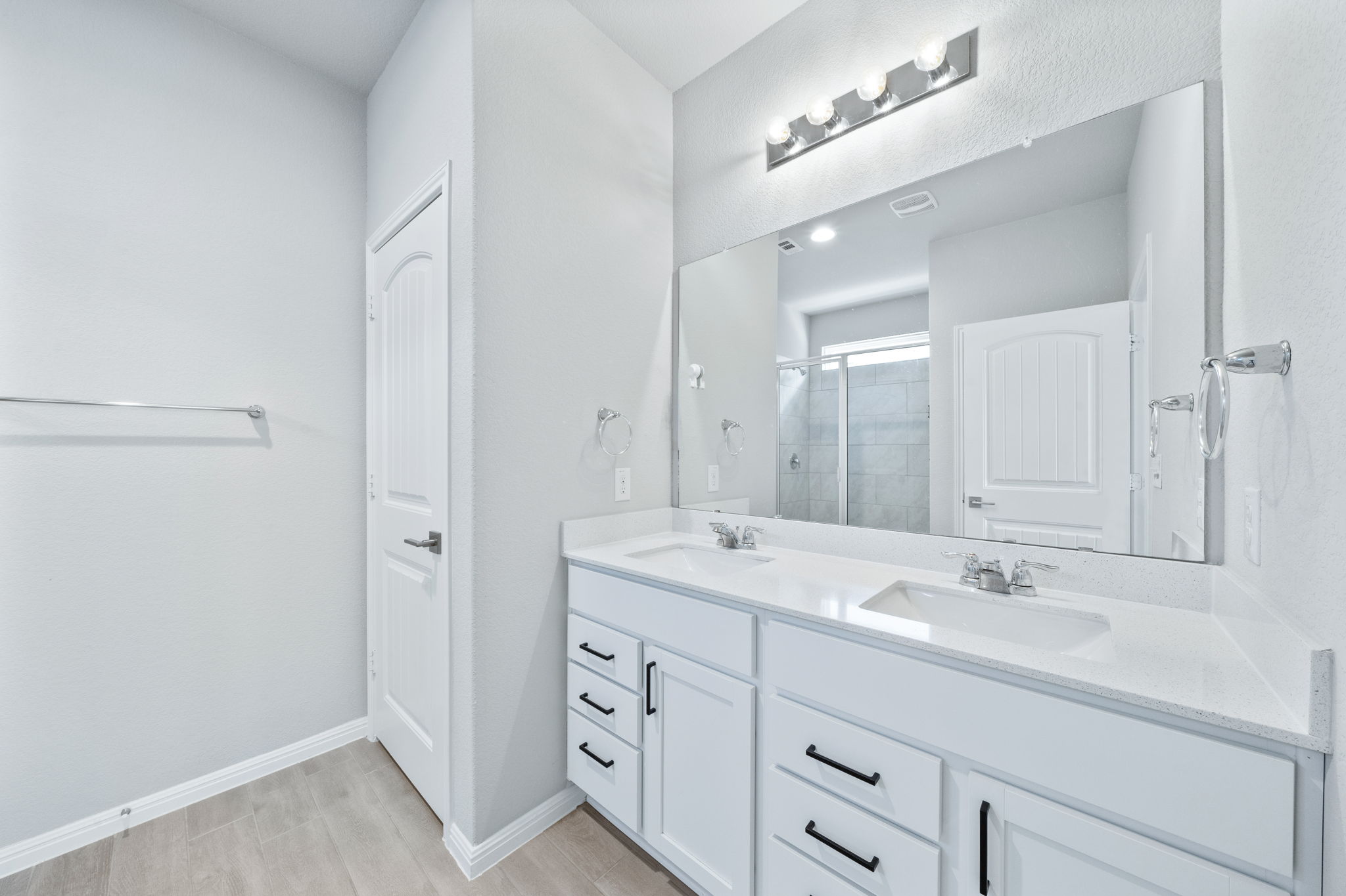 2412 Starhill Ranch Street Georgetown, TX 78628 - Photo 26 of 40 Double vanities and an oversized mirror create a highly functional and organized bathroom space.