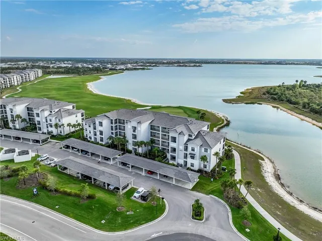 a aerial view of a house with a garden and lake view