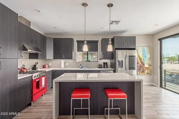 a kitchen with a stove a refrigerator and wooden cabinets