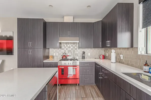 a kitchen with a sink a stove and cabinets