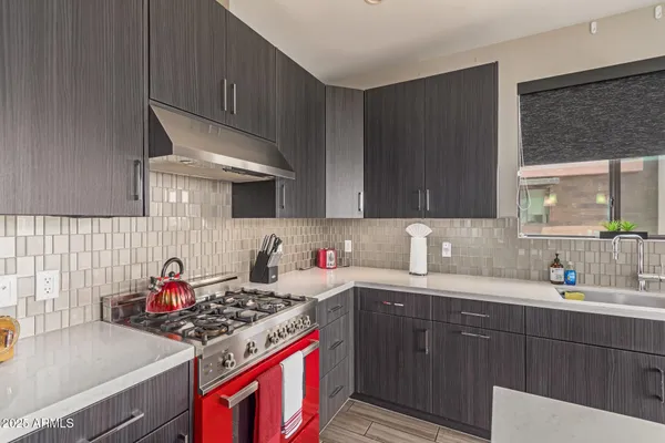 a kitchen with stainless steel appliances a sink stove and cabinets