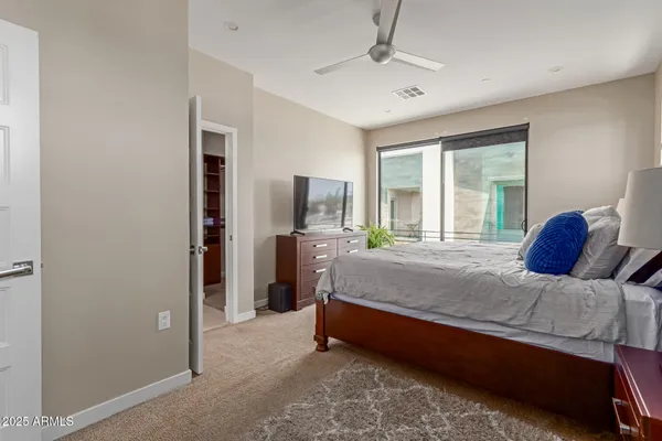 a bed room with a bed and a chair