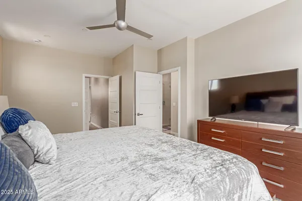 a bedroom with a bed and a flat screen tv