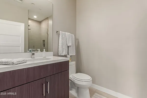 a bathroom with a sink a toilet and mirror