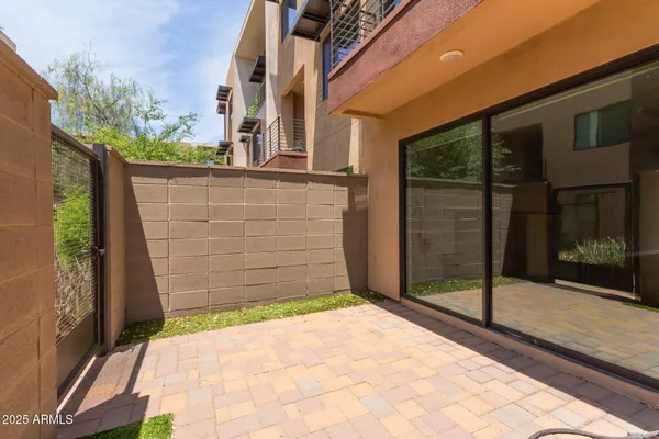 a view of entrance gate of a house with an outdoor space