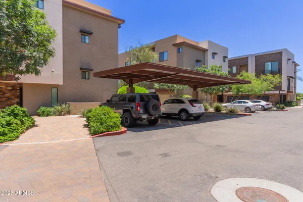 a couple of cars parked in front of a house