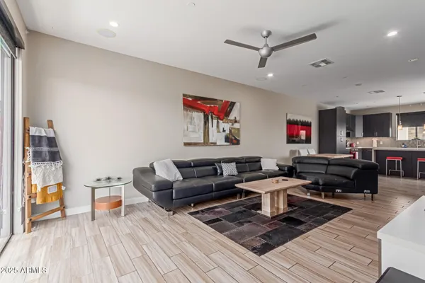 a living room with furniture and a wooden floor