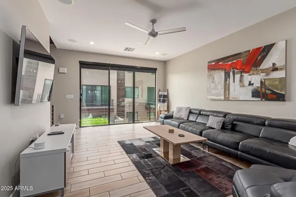 a living room with furniture and a floor to ceiling window