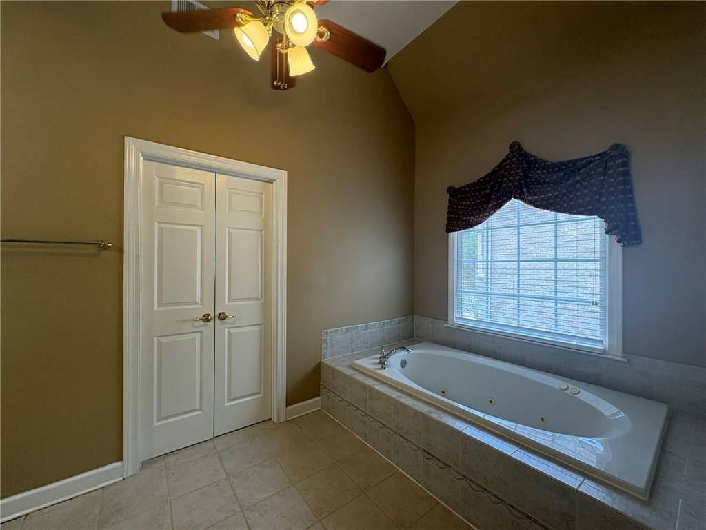 5930 Abbotts Run Trail Duluth, GA 30097 - Photo 16 of 32 a bathroom with a tub and a window
