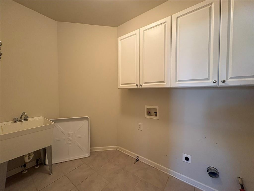 5930 Abbotts Run Trail Duluth, GA 30097 - Photo 22 of 32 a bathroom with a sink and cabinets
