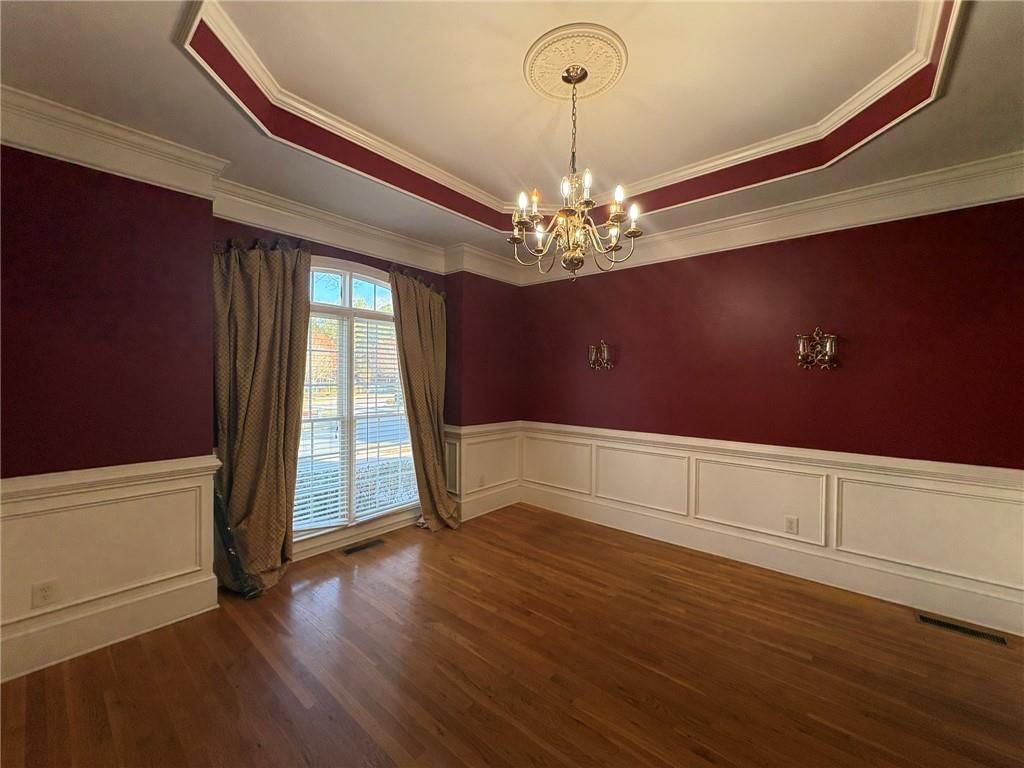 5930 Abbotts Run Trail Duluth, GA 30097 - Photo 3 of 32 an empty room with wooden floor chandelier and windows