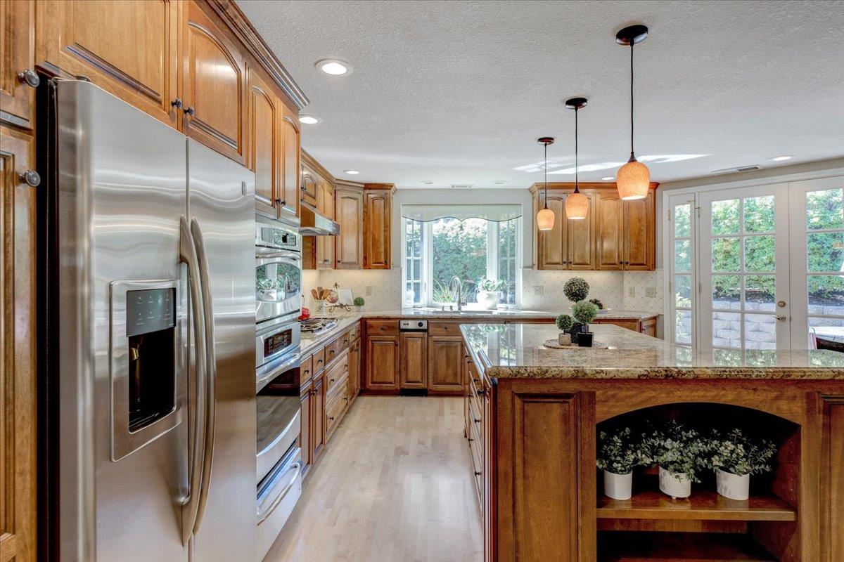 6763 Endmoor Drive San Jose, CA 95119 - Photo 11 of 32 a kitchen with stainless steel appliances granite countertop a stove a sink and a refrigerator