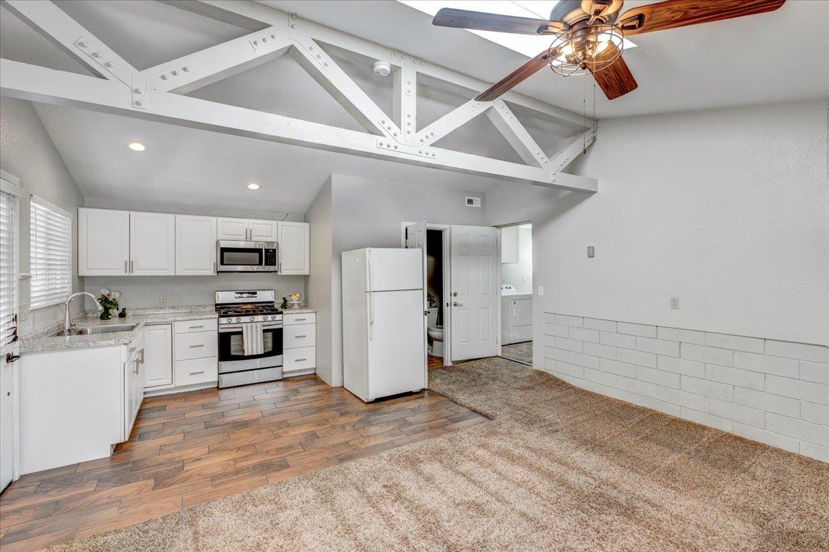 6763 Endmoor Drive San Jose, CA 95119 - Photo 25 of 32 a kitchen with stainless steel appliances kitchen island granite countertop a refrigerator and a stove top oven