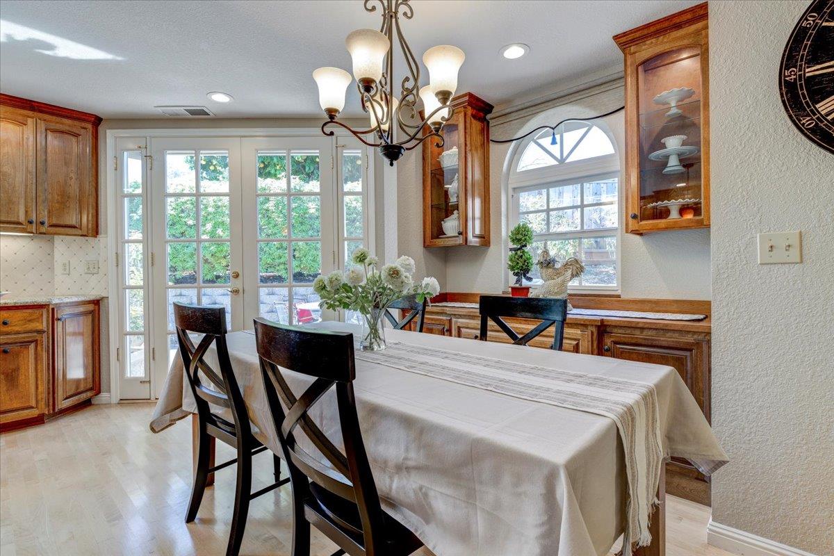 6763 Endmoor Drive San Jose, CA 95119 - Photo 8 of 32 a view of a dining room with furniture a chandelier and large windows
