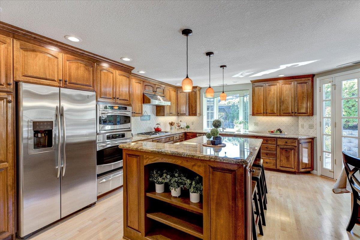 6763 Endmoor Drive San Jose, CA 95119 - Photo 9 of 32 a kitchen with stainless steel appliances granite countertop a stove refrigerator sink and cabinets