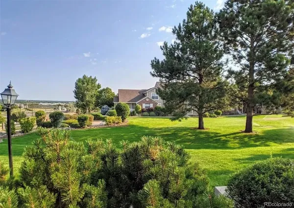 a backyard of a house with a yard and outdoor seating