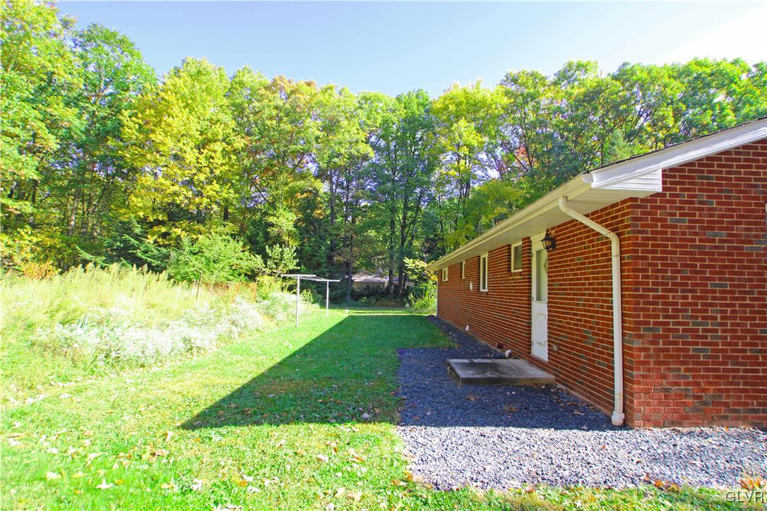 185 Hobby Acres Road Kunkletown, PA 18058 - Photo 5 of 28 a view of a backyard with plants and large trees