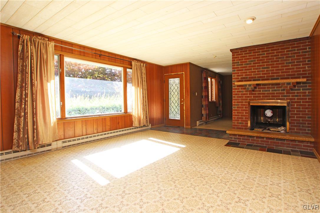 185 Hobby Acres Road Kunkletown, PA 18058 - Photo 8 of 28 a view of an empty room with a fireplace and a window