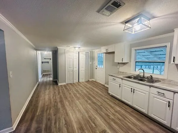 a large kitchen with kitchen island a sink stainless steel appliances and cabinets