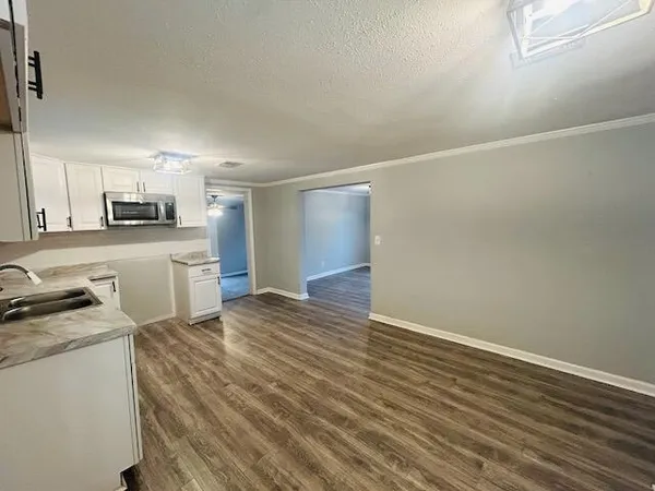a kitchen with granite countertop a stove and a refrigerator