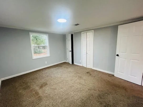 a view of an empty room with a window