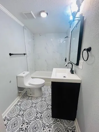 a bathroom with a sink toilet and mirror