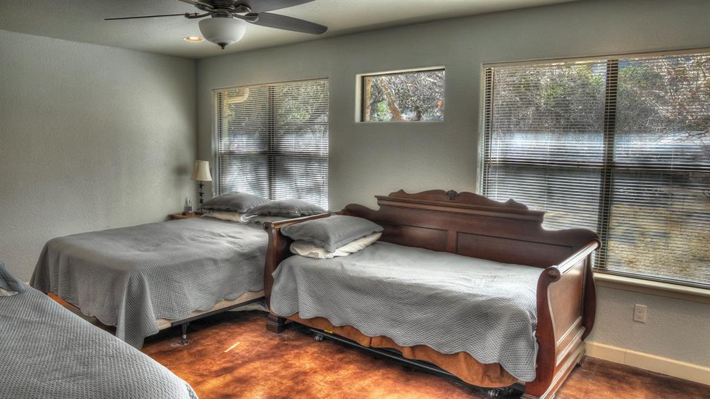 187 Roy Chisum Road Leakey, TX 78873 - Photo 15 of 40 a bedroom with double bed and window