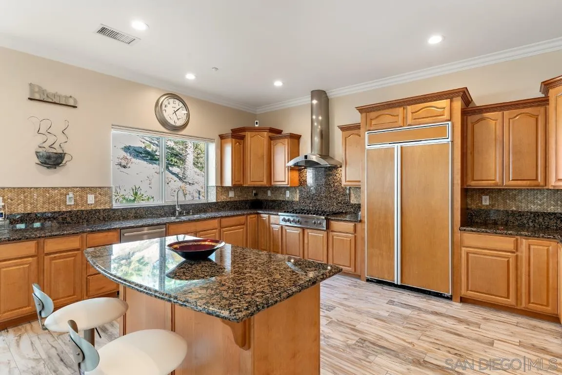 246 Yucca Road Fallbrook, CA 92028 - Photo 15 of 68 a kitchen with stainless steel appliances granite countertop a sink refrigerator and cabinets