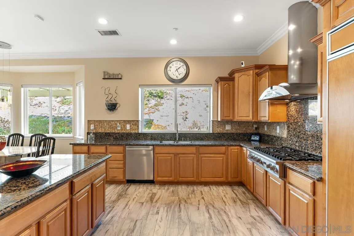 246 Yucca Road Fallbrook, CA 92028 - Photo 16 of 68 a large kitchen with granite countertop a sink and a stove