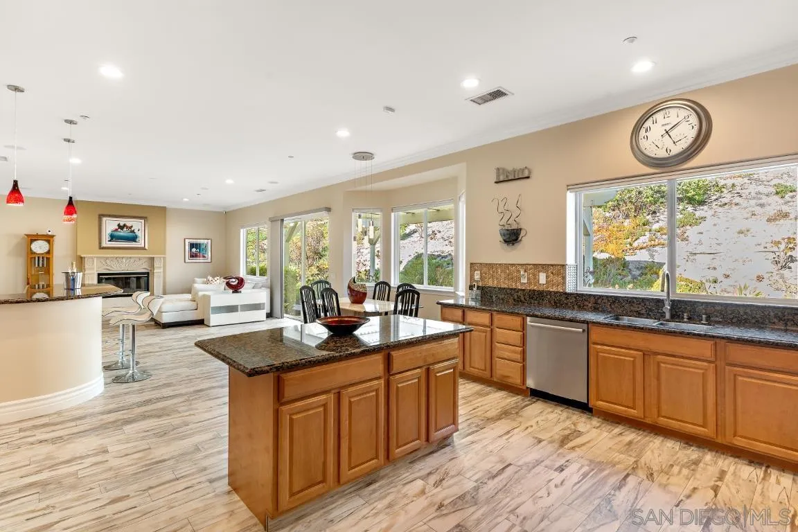 246 Yucca Road Fallbrook, CA 92028 - Photo 17 of 68 a large kitchen with stainless steel appliances granite countertop a stove and a wooden floors
