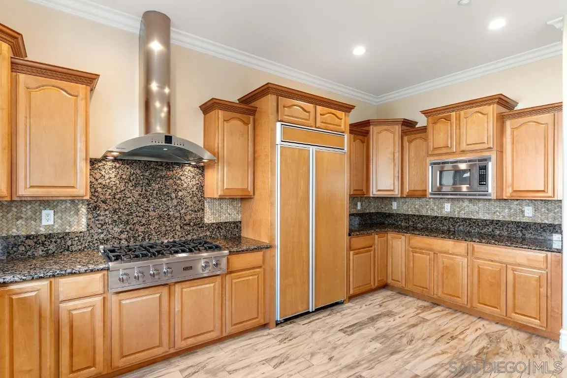 246 Yucca Road Fallbrook, CA 92028 - Photo 19 of 68 a kitchen with stainless steel appliances granite countertop a refrigerator and a sink