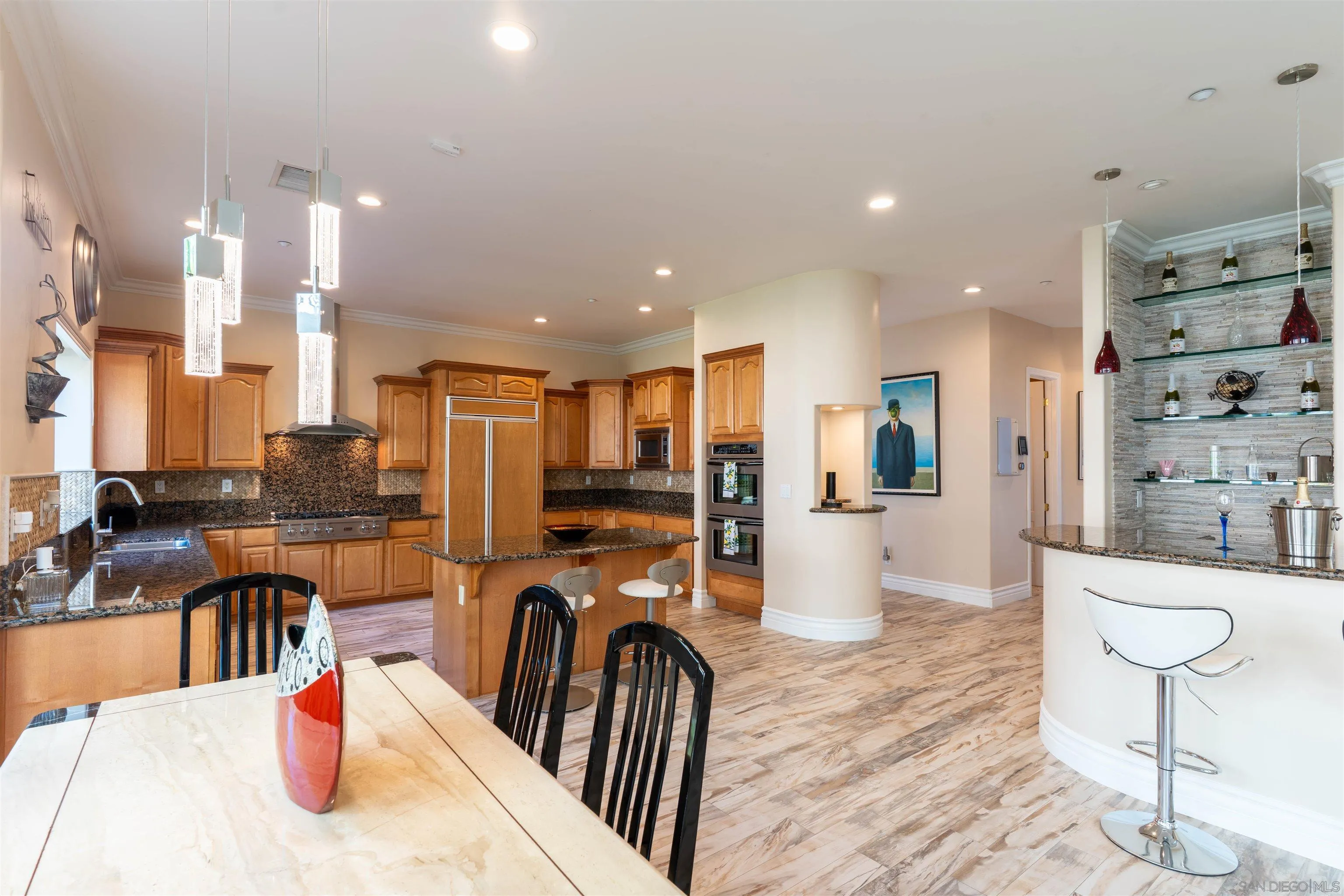 246 Yucca Road Fallbrook, CA 92028 - Photo 24 of 68 a kitchen with stainless steel appliances kitchen island granite countertop a refrigerator a stove a sink a dining table and chairs with wooden floor