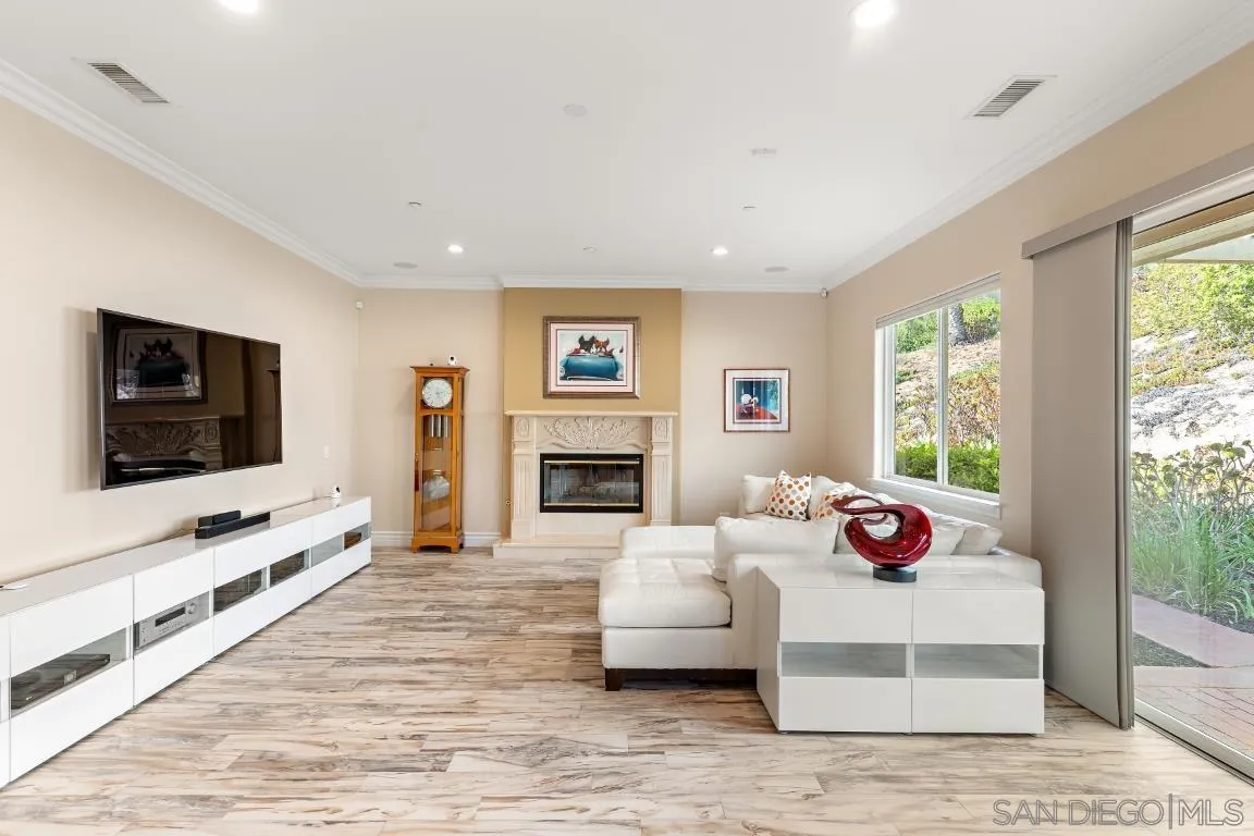 246 Yucca Road Fallbrook, CA 92028 - Photo 25 of 68 a bedroom with furniture a flat screen tv and a fireplace