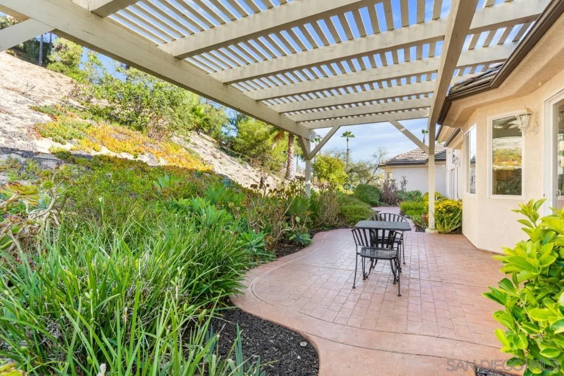 246 Yucca Road Fallbrook, CA 92028 - Photo 57 of 68 a view of a patio with table and chairs and potted plants with wooden floor