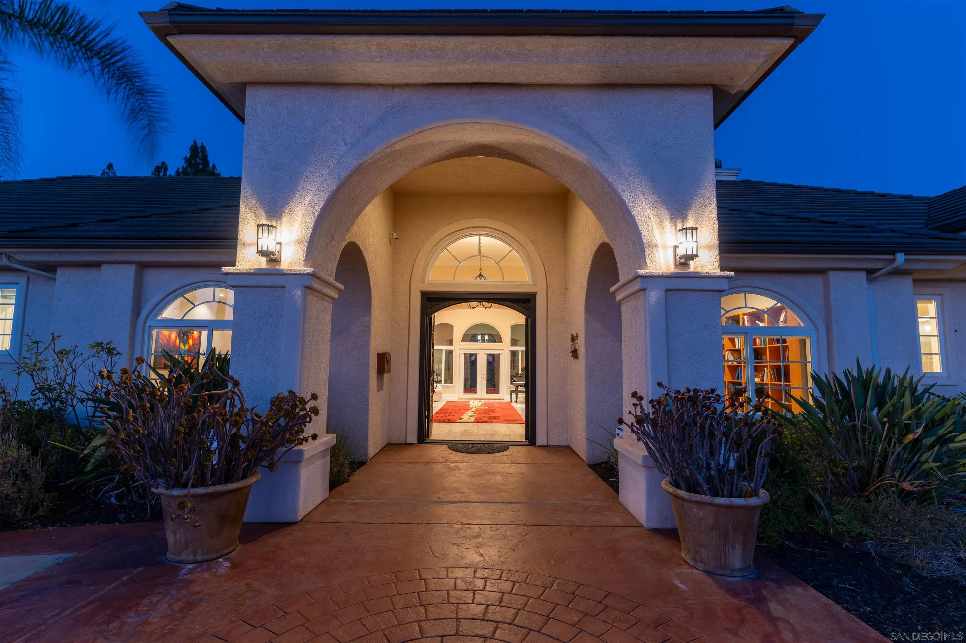 246 Yucca Road Fallbrook, CA 92028 - Photo 7 of 68 a view of a entryway door of the house with potted plants