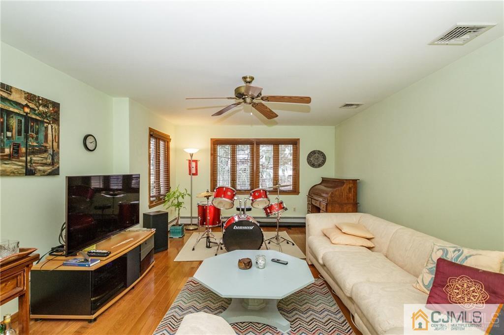 17 Garden Street East Hanover, NJ 07936 - Photo 11 of 34 a living room with furniture a fireplace and a flat screen tv