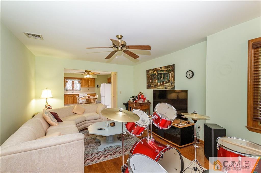 17 Garden Street East Hanover, NJ 07936 - Photo 12 of 34 a living room with furniture a bed and a chandelier