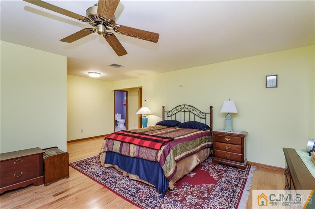 17 Garden Street East Hanover, NJ 07936 - Photo 19 of 34 a bedroom with a bed a dresser and potted plant