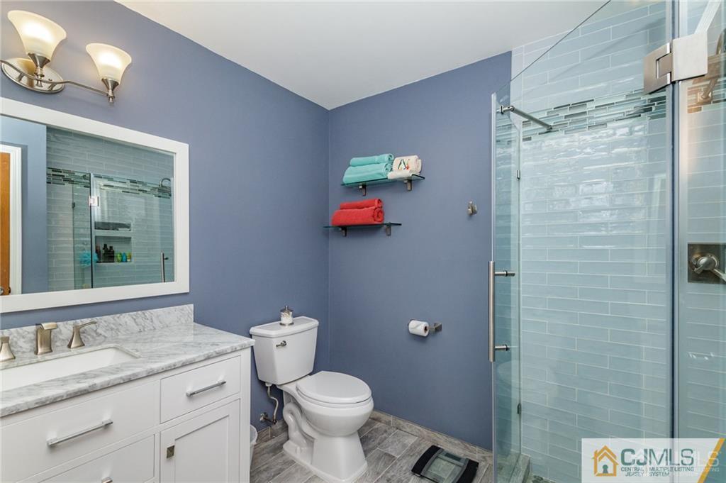 17 Garden Street East Hanover, NJ 07936 - Photo 21 of 34 a bathroom with a granite countertop sink toilet and a mirror