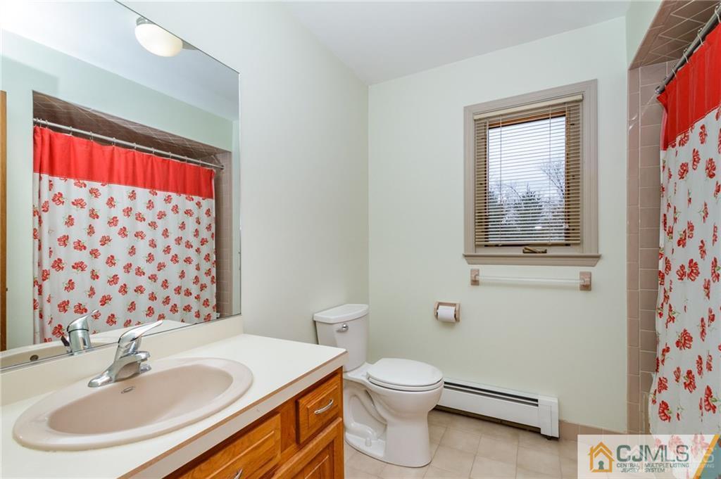 17 Garden Street East Hanover, NJ 07936 - Photo 23 of 34 a bathroom with a sink a toilet and shower curtain