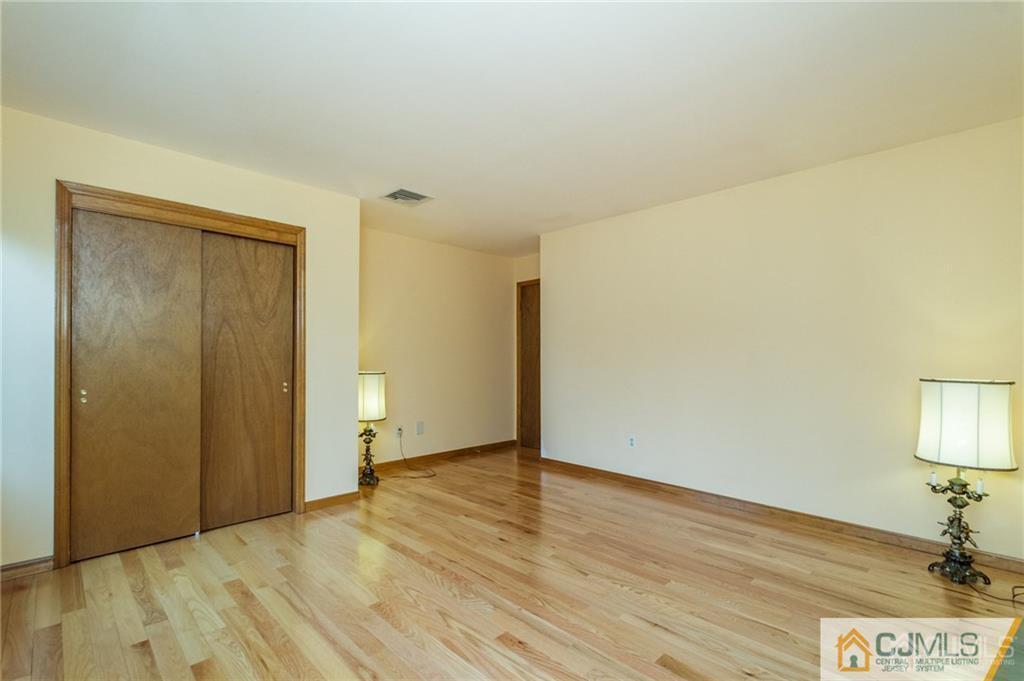 17 Garden Street East Hanover, NJ 07936 - Photo 26 of 34 an empty room with wooden floor and bathroom view